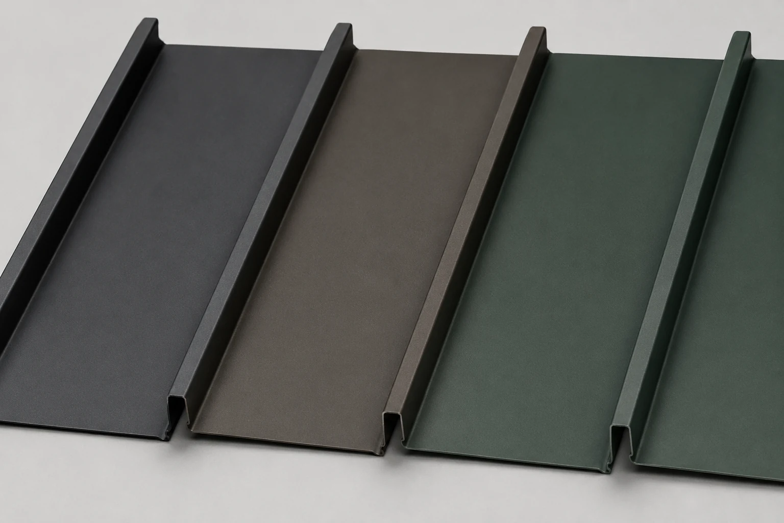 Standing seam metal roof color sample panels in matte charcoal, bronze, and forest green for Granville Ohio homes